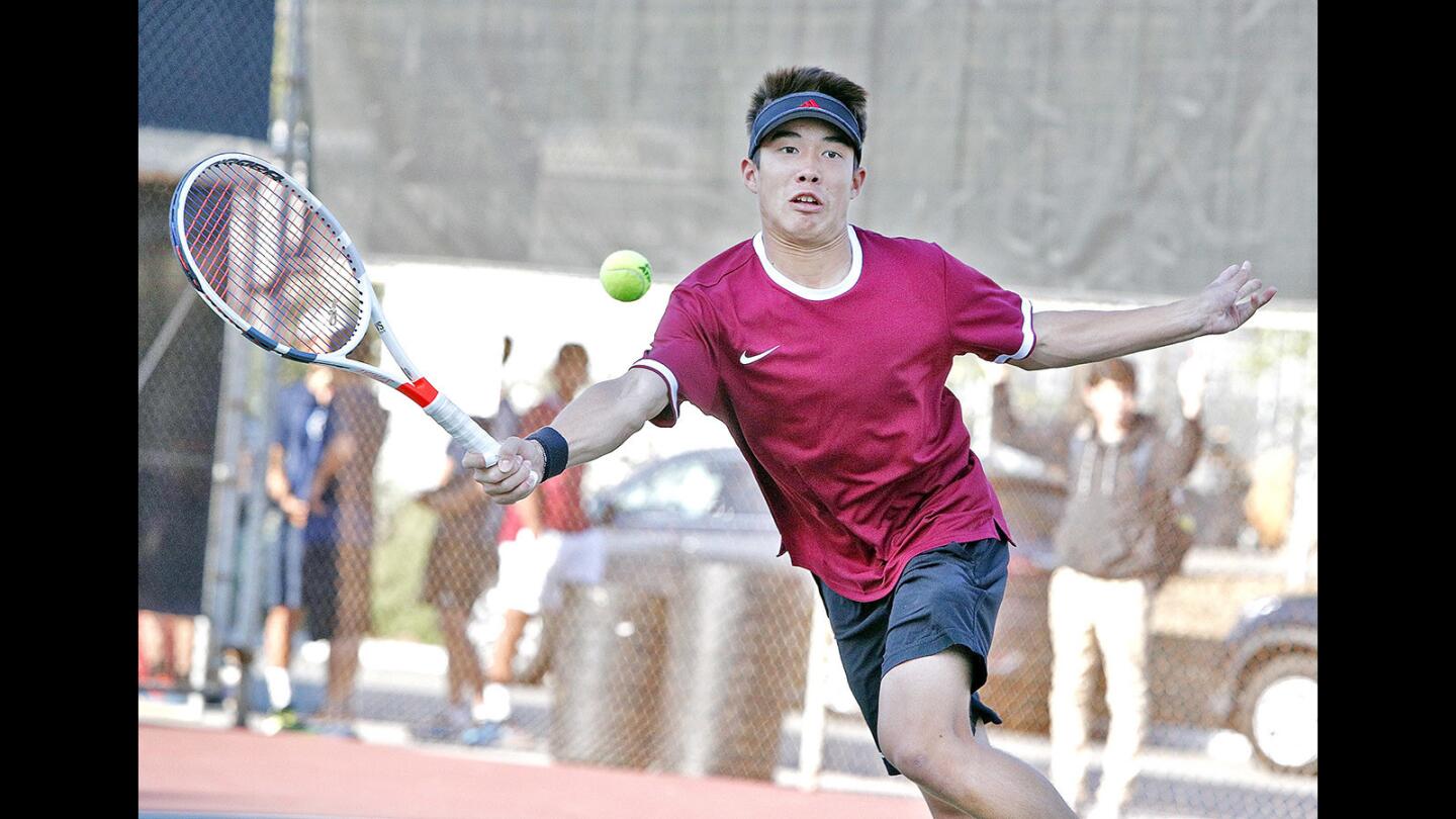 La Canada's Ryan Morgan charges the net and reacts to a shot for a forehand return against Crescenta Valley in a non-league boys' tennis match at La Canada High School on Thursday, March 8, 2018.