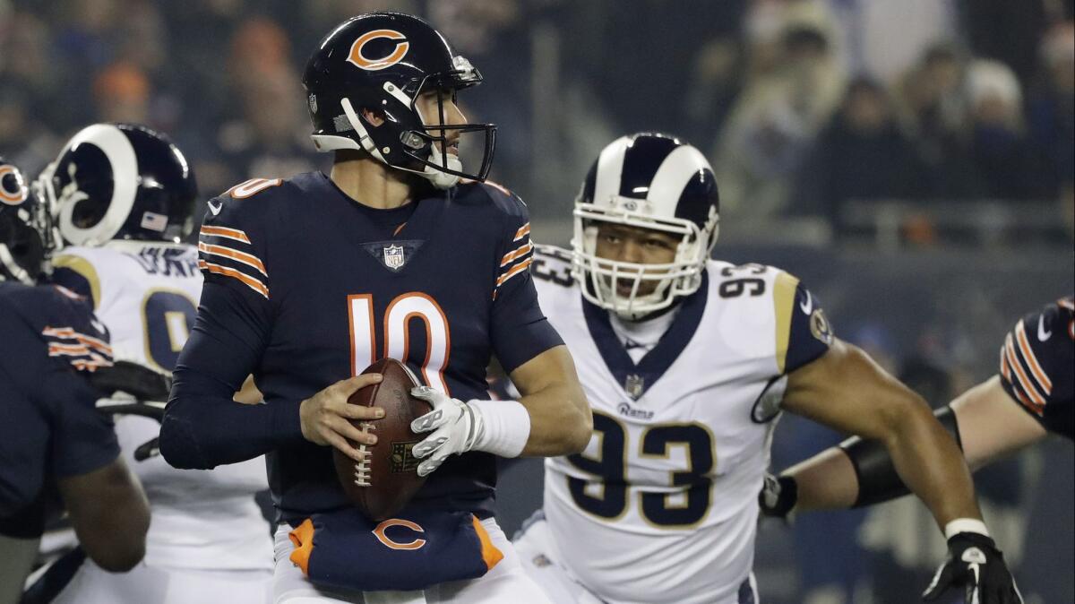 Chicago Bears quarterback Mitchell Trubisky (10) looks for a receiver as Rams' Ndamukong Suh (93) pressures him during the first half.