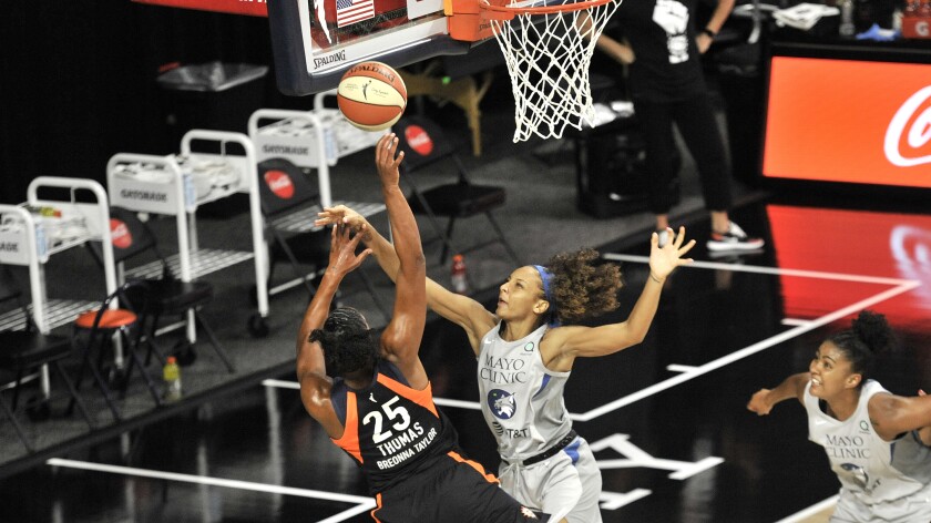 Connecticut Sun's Alyssa Thomas (25) shoots under pressure from Minnesota Lynx's Mikiah Herbert Harrigan during the first half of a WNBA basketball game Saturday, Aug. 1, 2020, in Bradenton, Fla. (AP Photo/Steve Nesius)