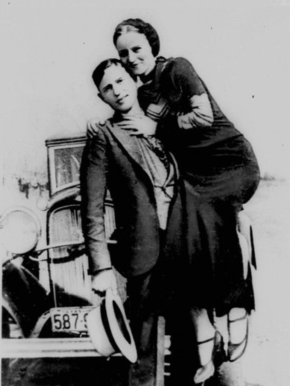 A man holds a woman on his hip