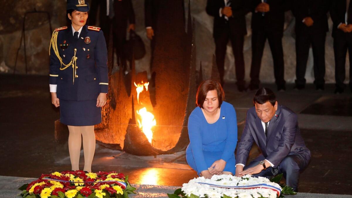 Philippine President Rodrigo Duterte and his daughter Sarah lay a wreath at the hall of remembrance at the Yad Vashem Holocaust memorial museum in Jerusalem on Monday.