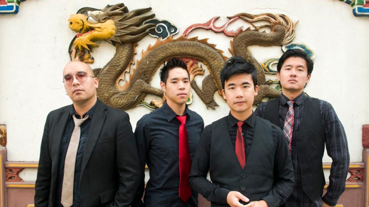 Asian American band the Slants, from left, Joe X Jiang, Ken Shima, Tyler Chen, Simon "Young" Tam, Joe X Jiang in Old Town Chinatown, Portland, Ore.