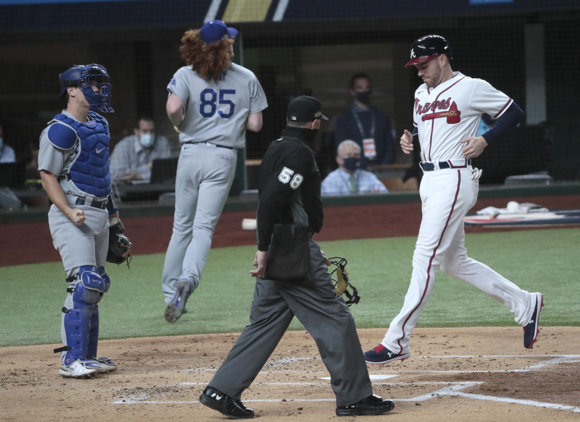 Atlanta's Freddie Freeman scores on a sacrifice fly in the first inning.