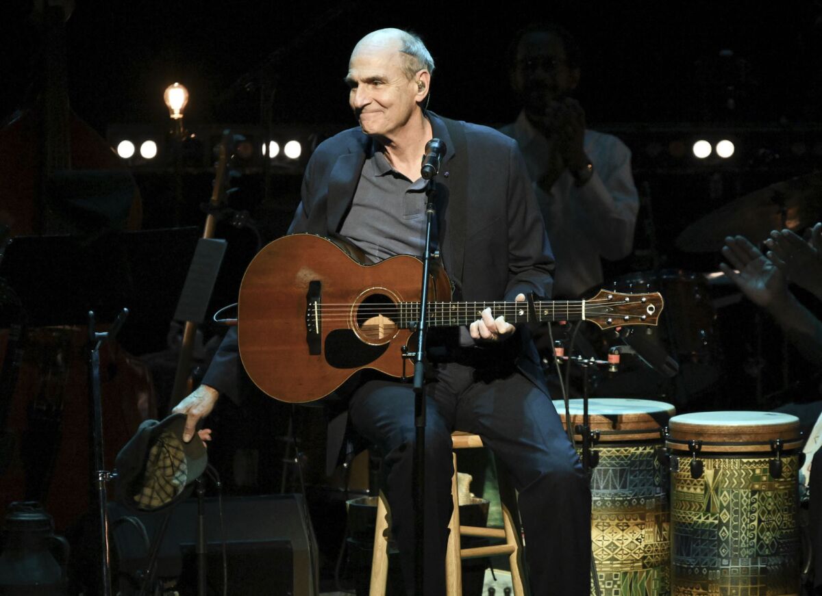 This Nov. 7, 2018 file photo shows James Taylor performing at JONI 75: A Birthday Celebration in Los Angeles. His 2020 joint concert tour with Jackson Browne was postponed on Friday because of the coronavirus pandemic.