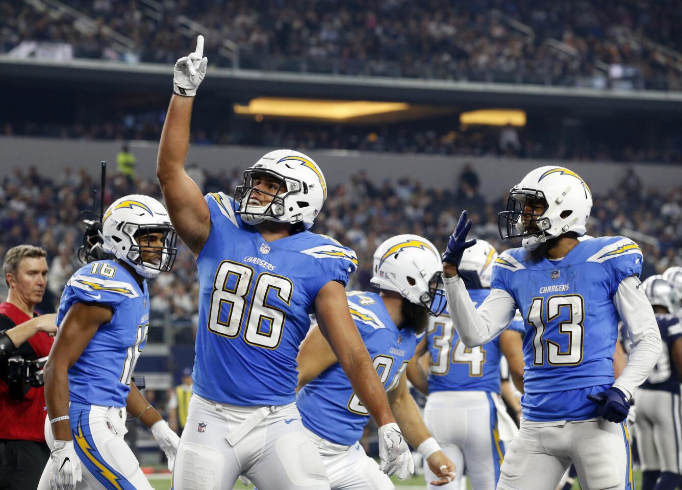 Chargers tight end Hunter Henry (86) celebrates his touchdown catch with teammates Tyrell Williams (16) and Keenan Allen (13) during the second half.