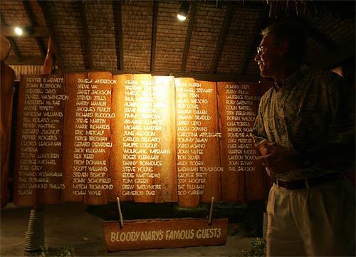 Proprietor Craig Goold checks out the list of celebrities who have visited Bloody Mary's on Povai Bay. Among the famous diners: Dudley Moore, the Carpenters, Johnny Depp and Drew Barrymore. The South Seas restaurant is famous for its seafood: Management buys the day's catch from local fishermen and serves it that evening.