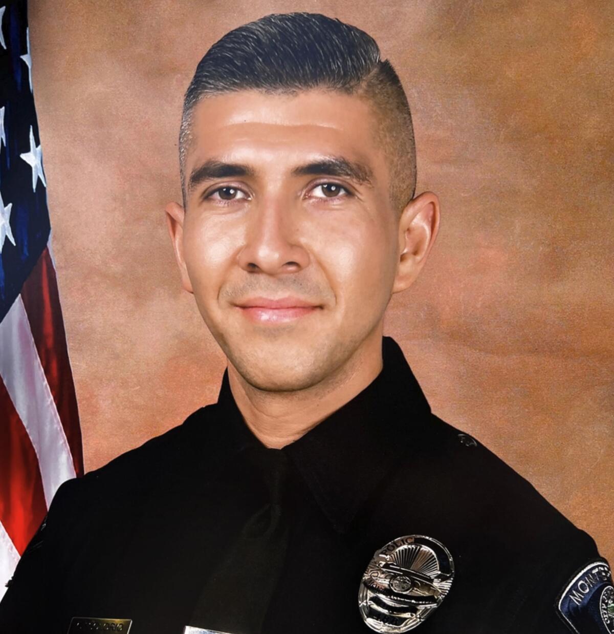 A portrait of a young man in a police uniform.