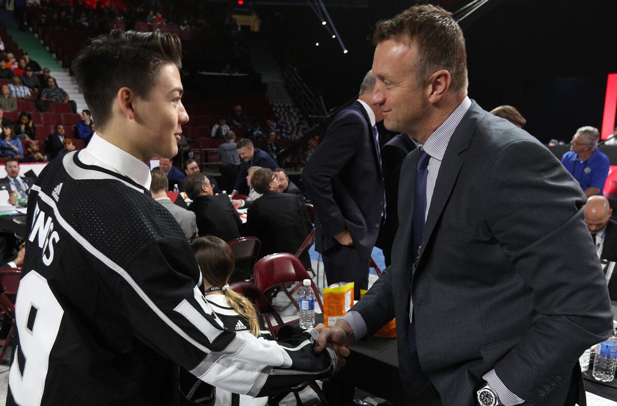 Jordan Spence, left, is greeted by Kings general manger Rob Blake after being selected 95th overall by the Kings in the 2019 NHL draft. Replenishing the Kings' farm system has been one of Blake's top priorities.