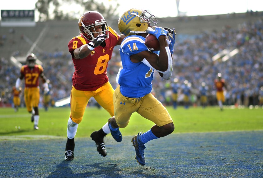 UCLA receiver Theo Howard catches a touchdown pass in front of USC defensive back Iman Marshall during the first quarter at the Rose Bowl on Nov. 17, 2018. The Bruins and Trojans will meet for the 89th time at the Coliseum on Saturday.