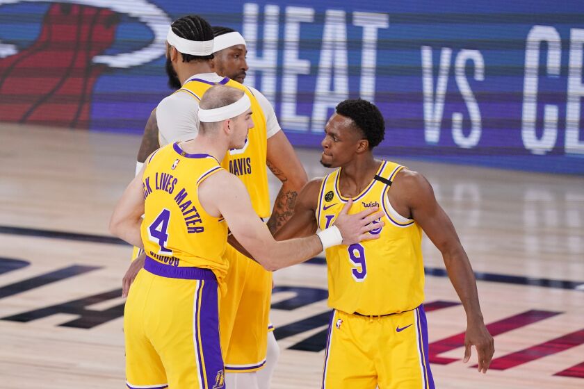 Los Angeles Lakers' Alex Caruso (4) and Rajon Rondo (9) congratulate one another after beating the Denver Nuggets in an NBA conference final playoff basketball game Thursday, Sept. 24, 2020, in Lake Buena Vista, Fla. (AP Photo/Mark J. Terrill)