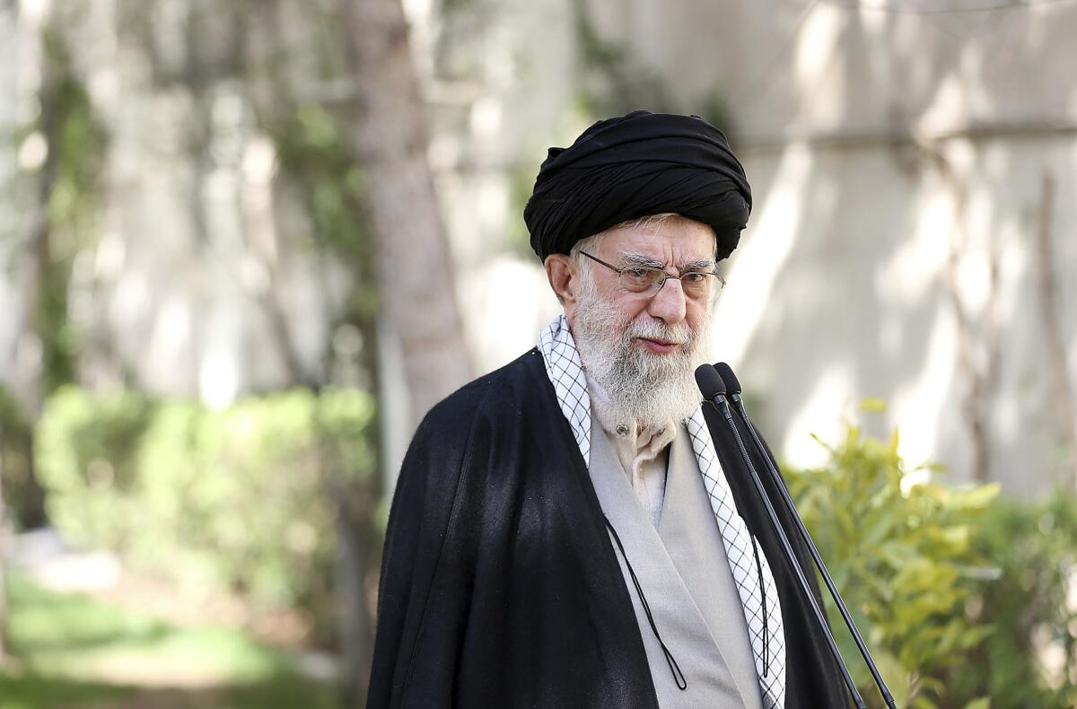 Iranian Supreme Leader Ayatollah Ali Khamenei stands in the courtyard of his office in Tehran.