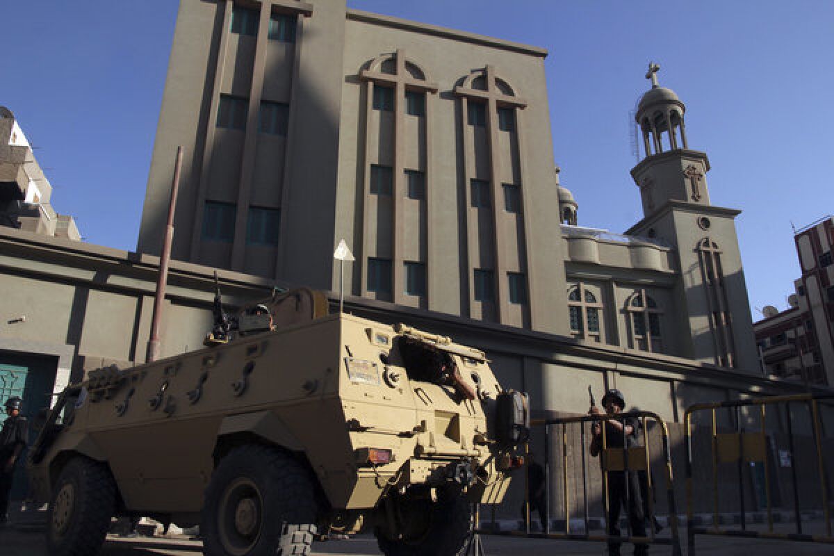 An Egyptian armored vehicle and army soldiers stand guard outside the main Christian Orthodox Cathedral in the southern city of Assiut, Egypt.