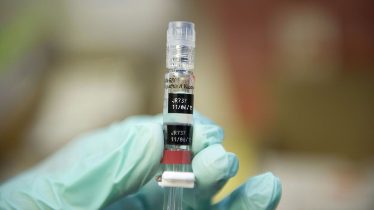 A nurse loads a syringe with a vaccine against hepatitis B. A new report from the National Academies of Sciences, Engineering, and Medicine presents a strategy for eliminating hepatitis B and C as public health problems in the U.S. by 2030.