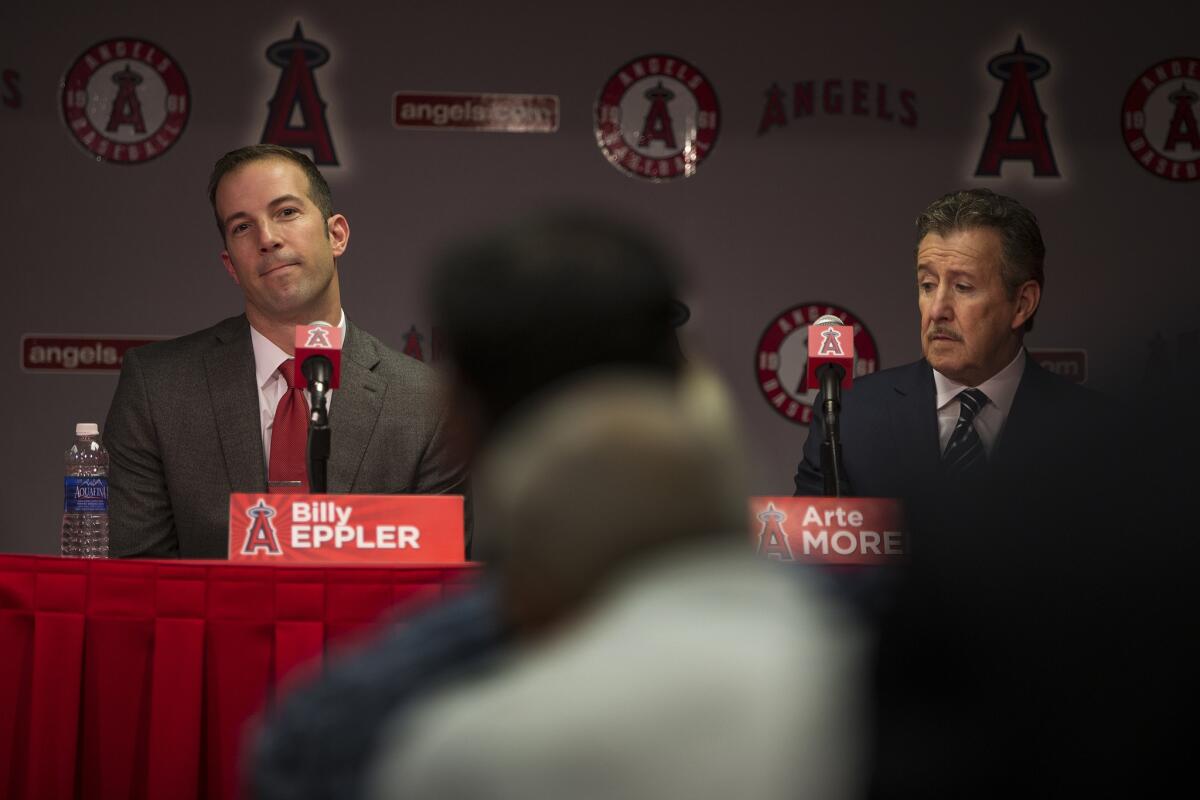 Seated next to owner Arte Moreno, right, Angels General Manager Billy Eppler answers media questions during an introductory news conference in October.