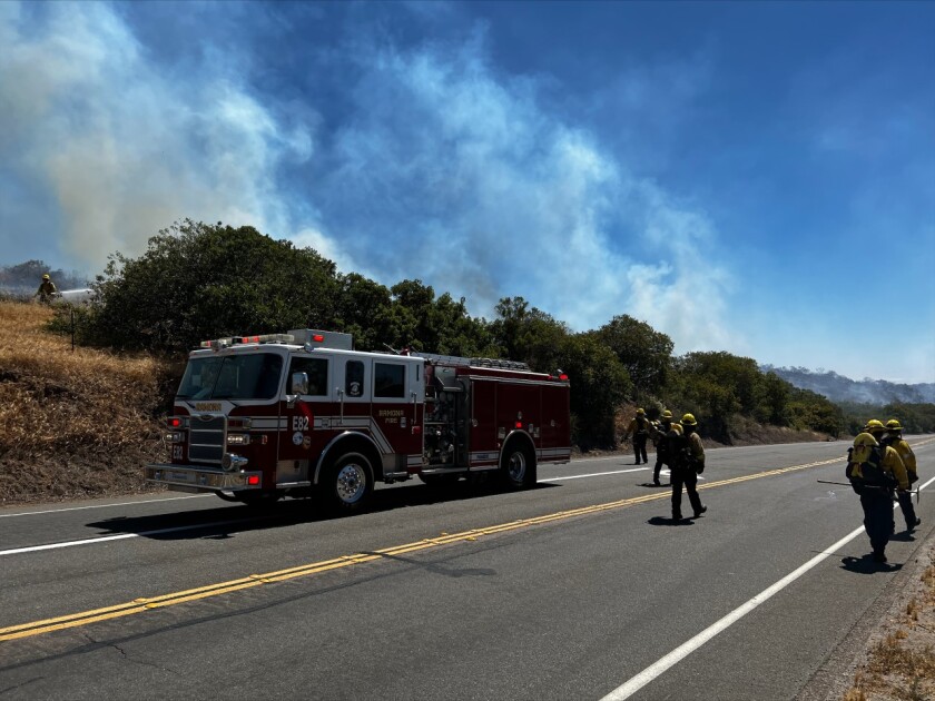 Crews respond to a vegetation fire off Poway Road on Friday afternoon.