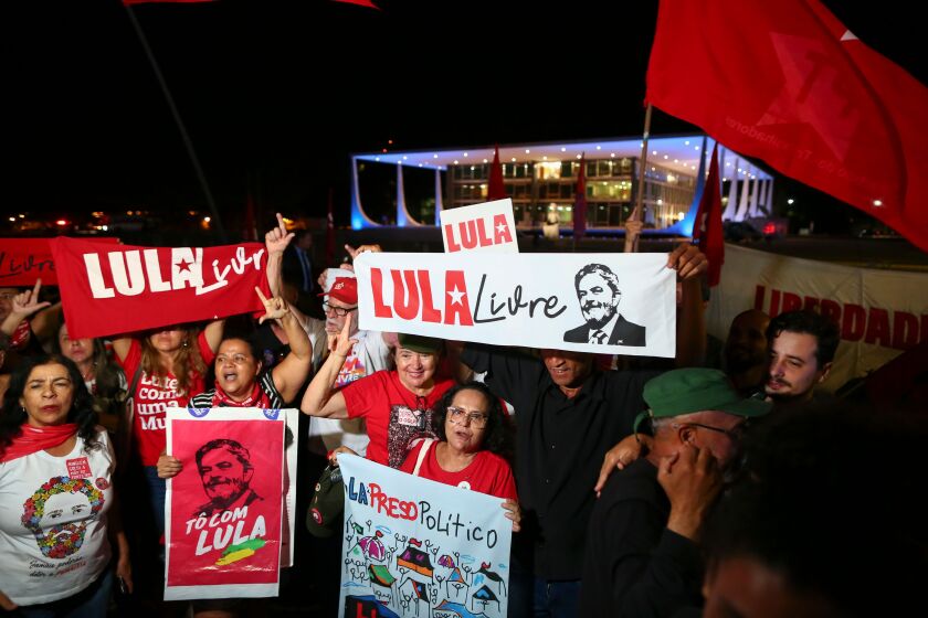 Supporters of former Brazilian President Luiz Inacio Lula da Silva celebrate a Supreme Court's ruling that could benefit him in Brasilia on November 7, 2019. - Brazil's Supreme Court voted Thursday to overturn a ruling requiring convicted criminals to go to jail after losing their first appeal, paving the way for leftist icon Luiz Inacio Lula da Silva to be freed. (Photo by STR / AFP) (Photo by STR/AFP via Getty Images) ** OUTS - ELSENT, FPG, CM - OUTS * NM, PH, VA if sourced by CT, LA or MoD **