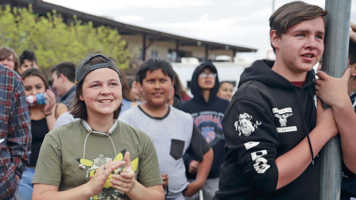 Priya Hasham and Miguel Alvarez listen to a speaker during the local Stand for the 2nd Walkout rally Wednesday at the Academy for Technology and the Classics in Santa Fe, N.M.