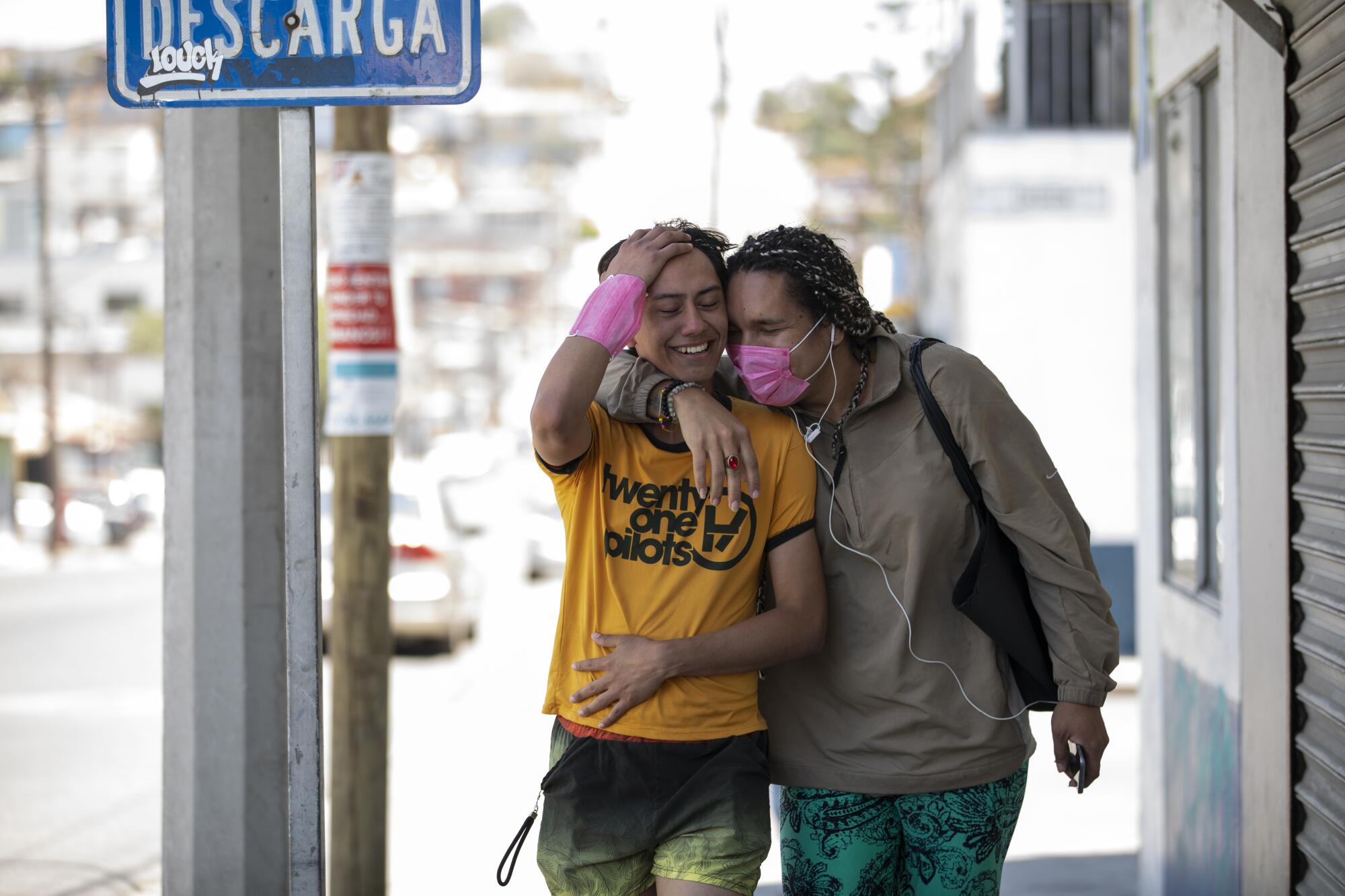 Ceidy Zethare and Emy Abrego hold each other with excitement as they walk down the street