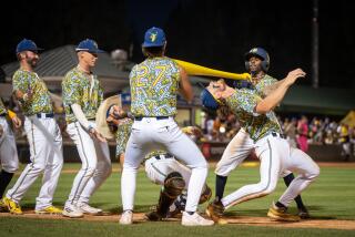 Savannah Bananas players do the limbo during a game Friday in Rancho Cucamonga
