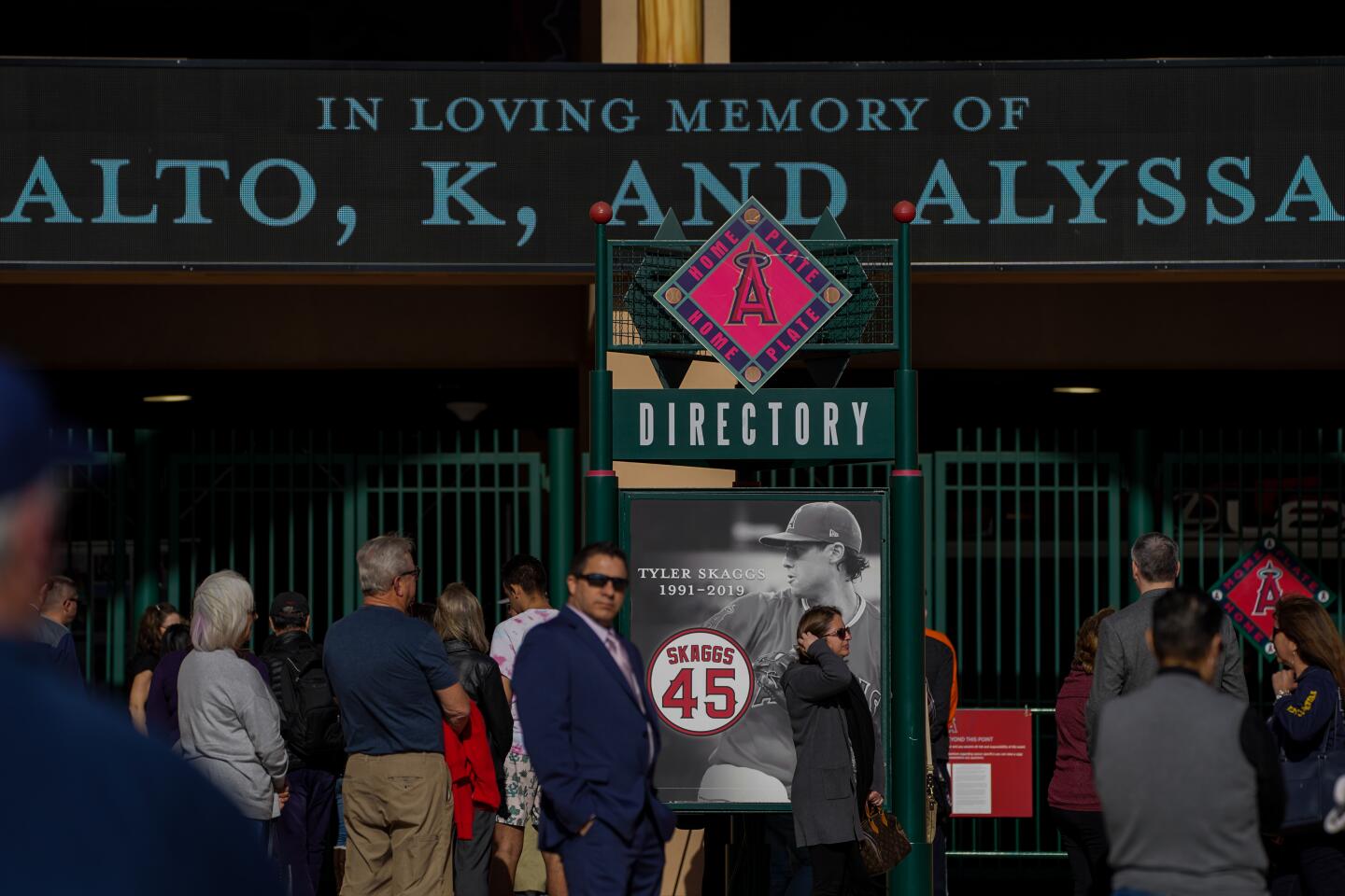 People wait outside the gates before the start of a celebration of life ceremony at Angel Stadium on Monday in Anaheim.