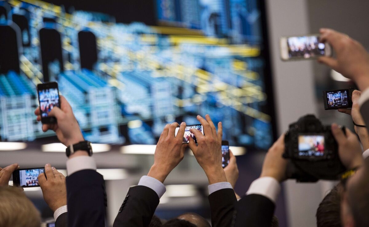 A report released Thursday said 4.5 million smartphones were lost or stolen in the U.S. in 2013. Above, guests and visitors take pictures with their smartphones during the opening of the Hannover Messe industrial trade fair in Hanover, Germany.