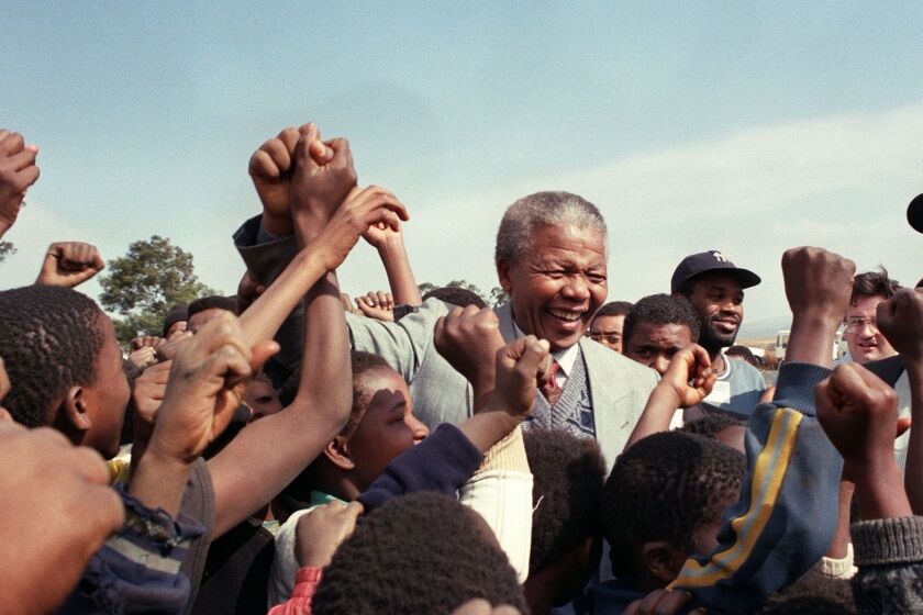 ANC president Nelson Mandela is surrounded by young supporters after addressing residents at Phola Park, a squatter settlement east of Johannesburg, 31 May 1992. AFP PHOTO / WALTER DHLADHLAWALTER DHLADHLA/AFP/Getty Images ORG XMIT: