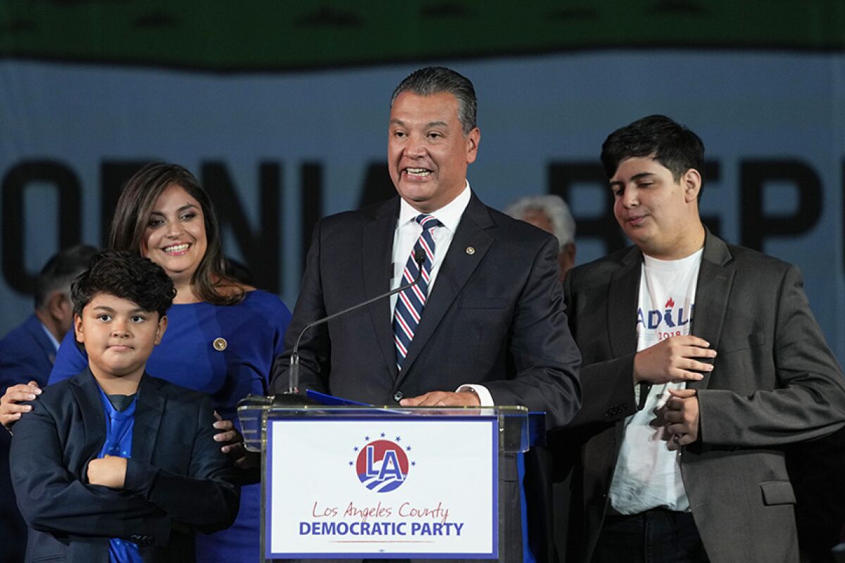 Sen. Alex Padillais joined by his family as he speaks at an election night party in Los Angeles on Nov. 8.