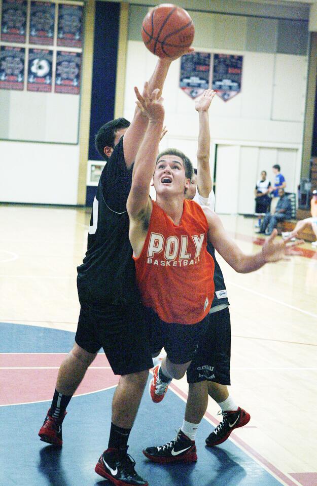 Poly's Will Genske, Jr. attempts to slice through Glendale's Erik Ebrahim and Eddie Uluchyan, but travels, in the second quarter of a boys summer league basketball game at Maranatha High School.