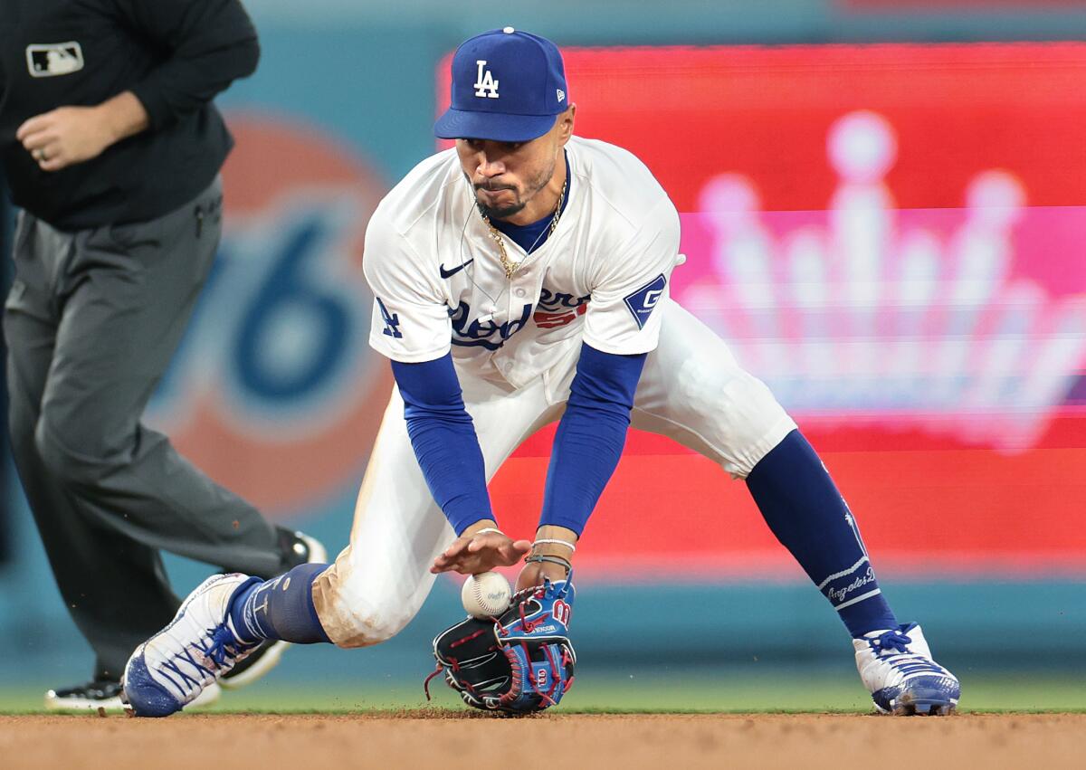 Dodgers shortstop Mookie Betts fields the ball against the Rangers during the 2024 season.