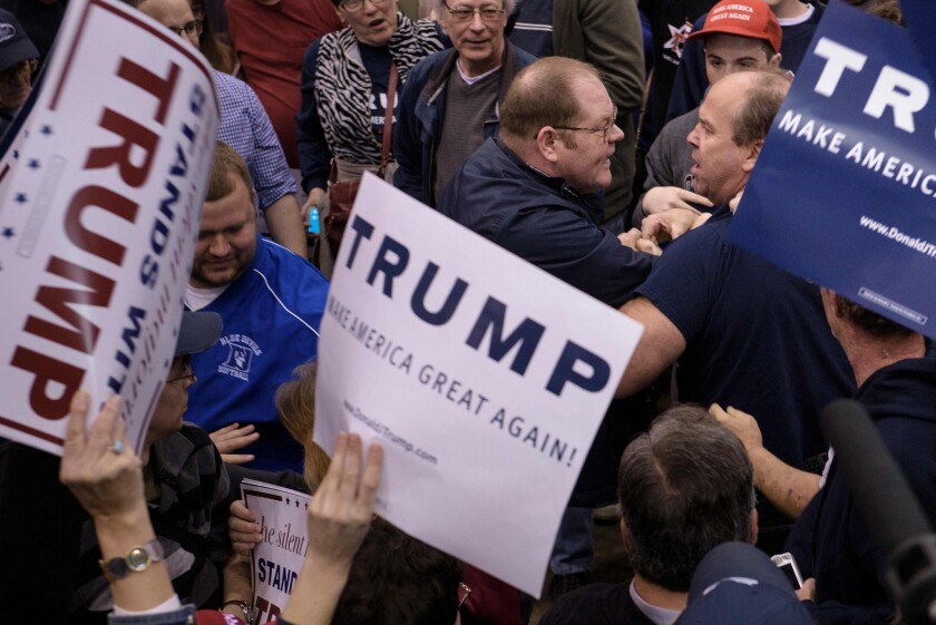 Attendees clash during a Trump rally at the International Exposition Center in Cleveland, Ohio on March 12.