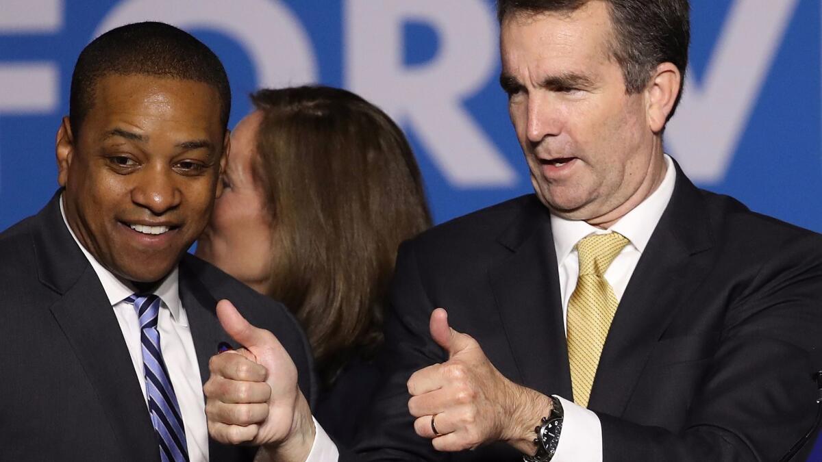 Gov.-elect Ralph Northam, right, and Lt. Gov.-elect Justin Fairfax greet supporters at a Democratic election night rally in Fairfax, Va.
