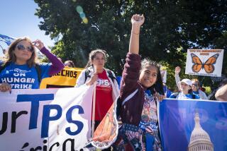 FILE - Marilyn Miranda, 12, of Washington, center, raises her hand up during a protest for an extension of the Temporary Protected Status (TPS) program, Sept. 23, 2022, at Lafayette Park by the White House in Washington. The Biden administration said Tuesday, June 13, 2023, that it will extend legal status for more than 300,000 people from El Salvador, Honduras, Nicaragua and Nepal 18 months, disappointing some advocates and members of Congress who sought a more generous offer. (AP Photo/Jacquelyn Martin, File)