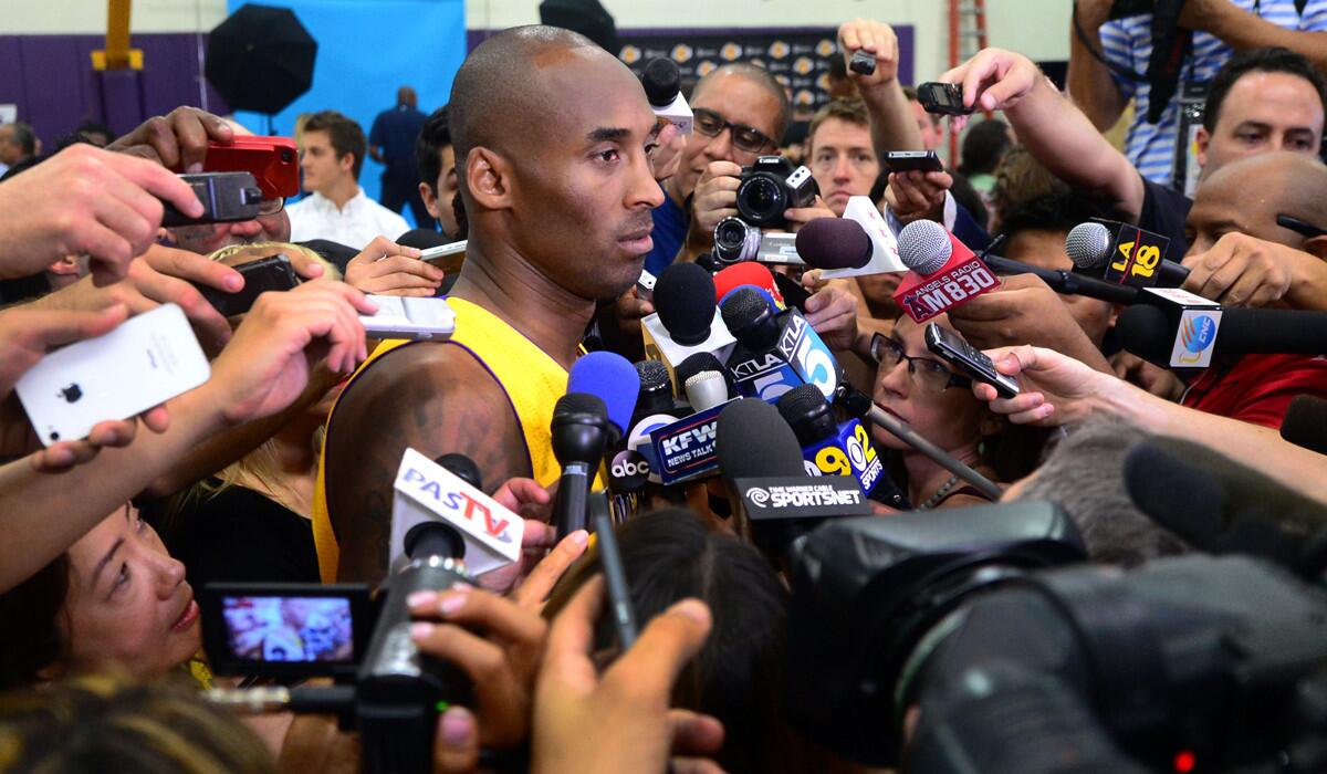 Lakers guard Kobe Bryant is surrounded by reporters and photographers during media day in El Segundo.