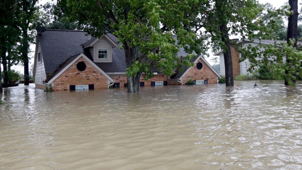 In this Aug. 28 photo, a home is surrounded by floodwaters from Tropical Storm Harvey in Spring, Texas.