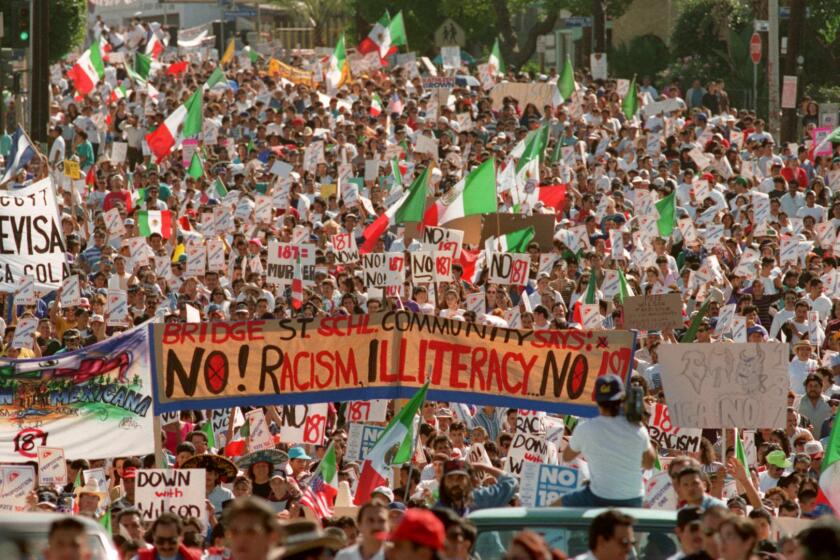 Oct. 16, 1994: Thousands march down Cesar E. Chavez Avenue near downtown Los Angeles denouncing Proposition 187 which would deny services to illegal immigrants. This image appeared in the Oct. 17, 1994, Los Angeles Times.