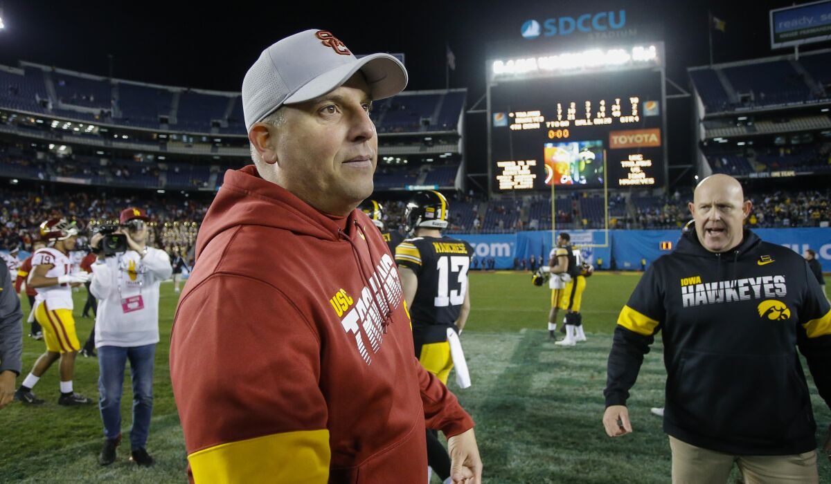 USC coach Clay Helton walks on the field after the Trojans' loss to Iowa in the Holiday Bowl.