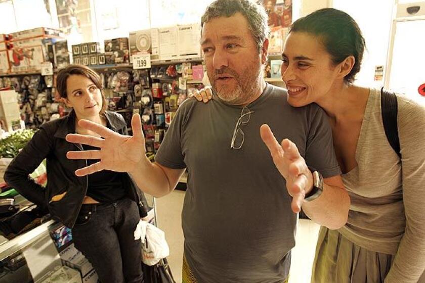 Famed designer Philippe Starck, his wife, Jasmine, right, and daughter Ara go shopping at a Big Lots store in Hollywood to show how far a dollar can go in recessionary times. In a time of financial crisis, we must go back to timeless objects and rediscover the elegance of basics, says Starck, the designer behind L.A. hot spots such as the restaurant Katsuya. Can you live elegantly and economically? We shall see. Give me 20 minutes, says the designer of furniture, accessories and other products.