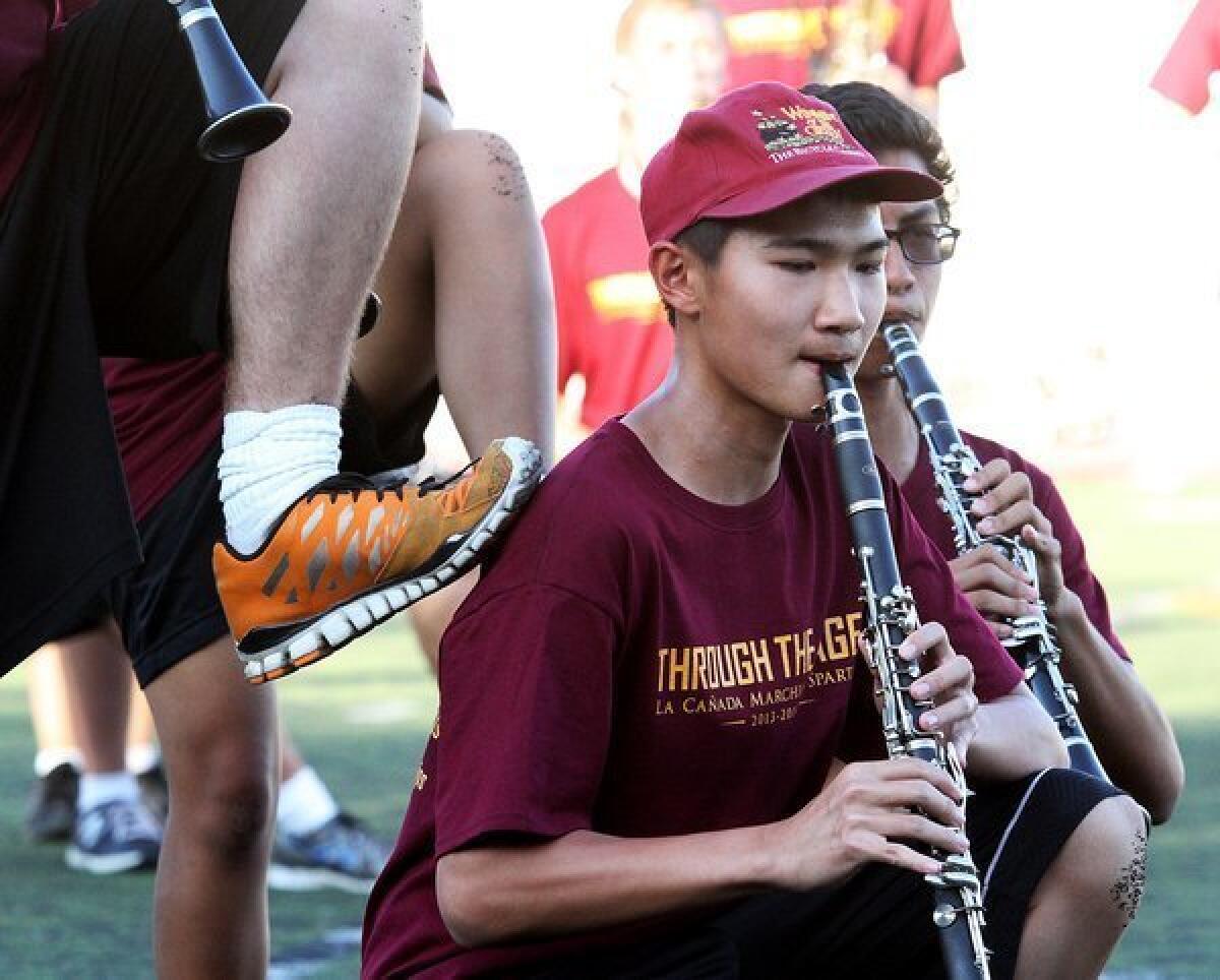The La Canada High School Marching Band practices a performance for the upcoming home football game for parents and friends of the school on Thursday, August 15, 2013.
