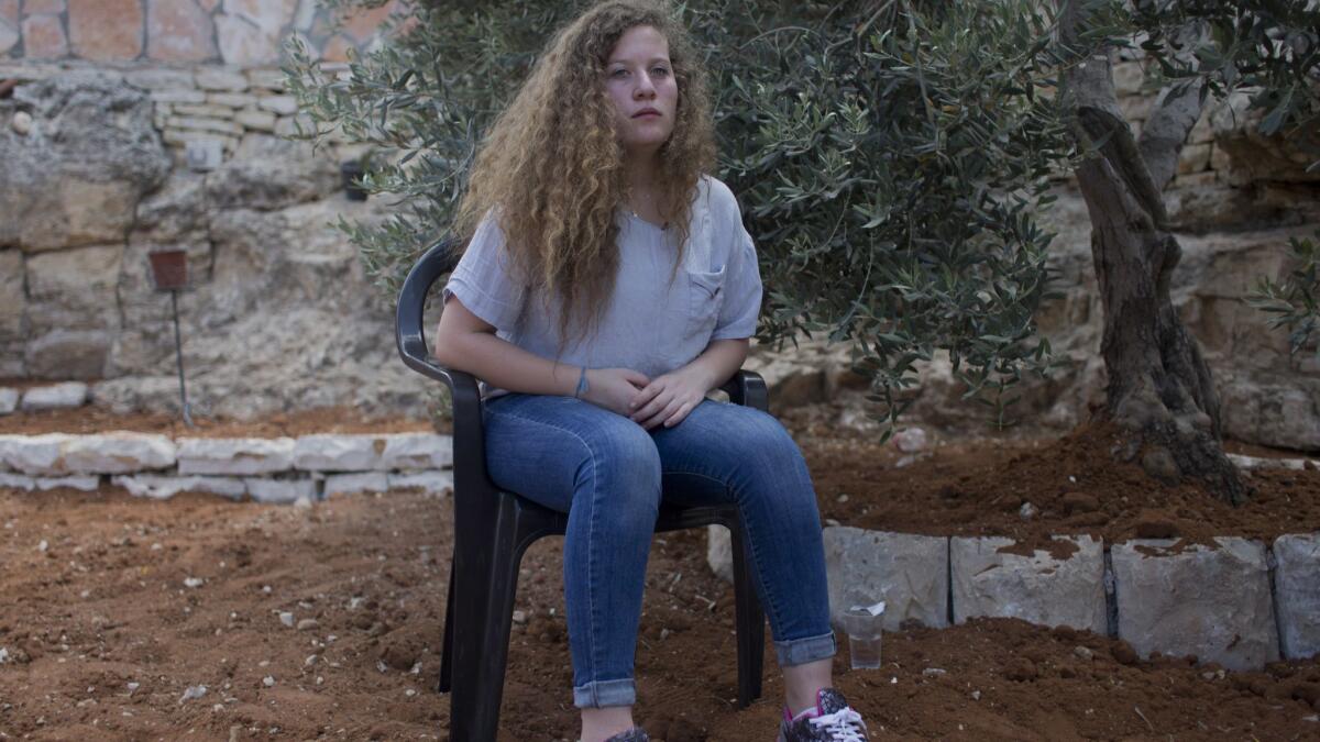 Ahed Tamimi sits July 30 in the backyard of her family house in the West Bank village of Nebi Saleh, near Ramallah.