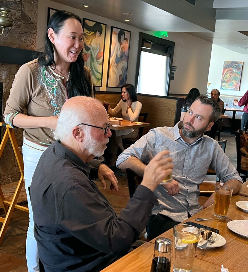 Vietnamese American film producer Naja Lockwood says a few words about Pulitzer Prize winner David Hume Kennerly, left.