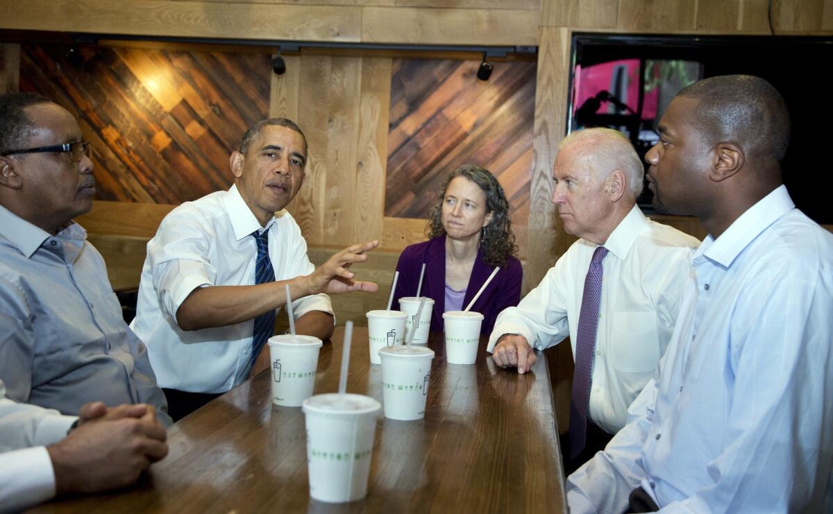 President Obama, accompanied by Vice President Joe Biden, meets with, from left, Abdullahi Mohamed, Meredith Upchurch and Antonio Byrd at the Shake Shack in Washington.