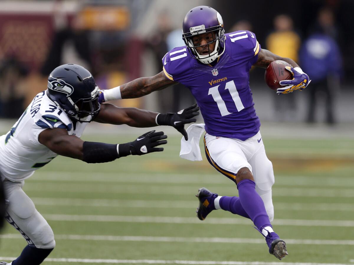 Minnesota wide receiver Mike Wallace is pushed out of bounds by Seattle strong safety Kam Chancellor on Dec. 6.