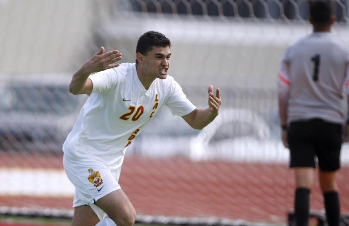 La Cañada High's Armen Eyssakhanian celebrates the game-clinching penalty kick in the Spartans' 0-0 (5-3) CIF Southern Section Division VI quarterfinal win over No. 1 seed Nogales on Saturday.