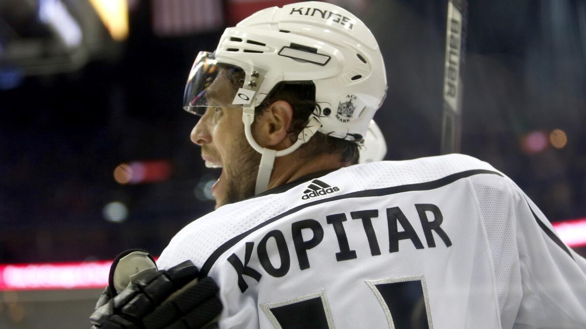 Kings center Anze Kopitar celebrates with a teammate after scoring a goal against the Blue Jackets during the third period Saturday.