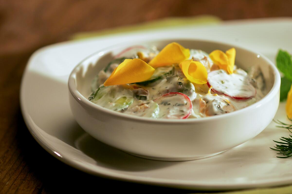 Edible flower petals top a Persian cucumber salad