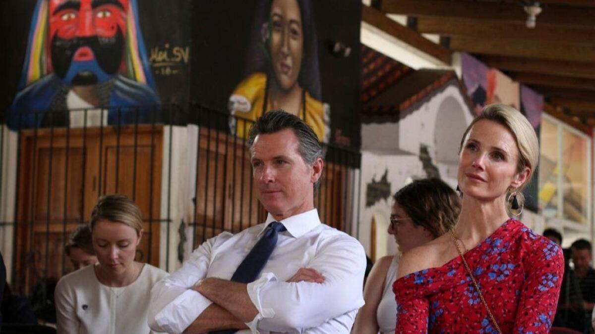 Gov. Gavin Newsom and his wife, Jennifer Siebel Newsom, listen to a recital of violins by young Salvadorans in Panchimalco, El Salvador, on April 8.