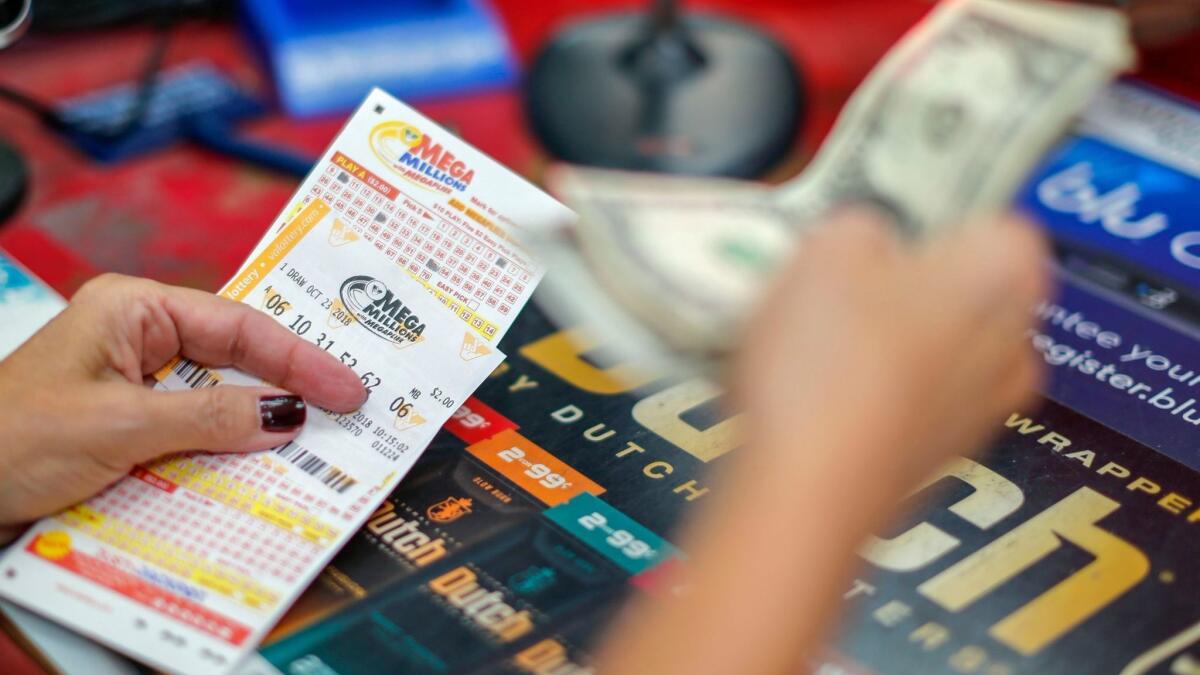 A customer purchases Mega Millions lottery tickets at a retailer in Arlington, Va., on Monday.