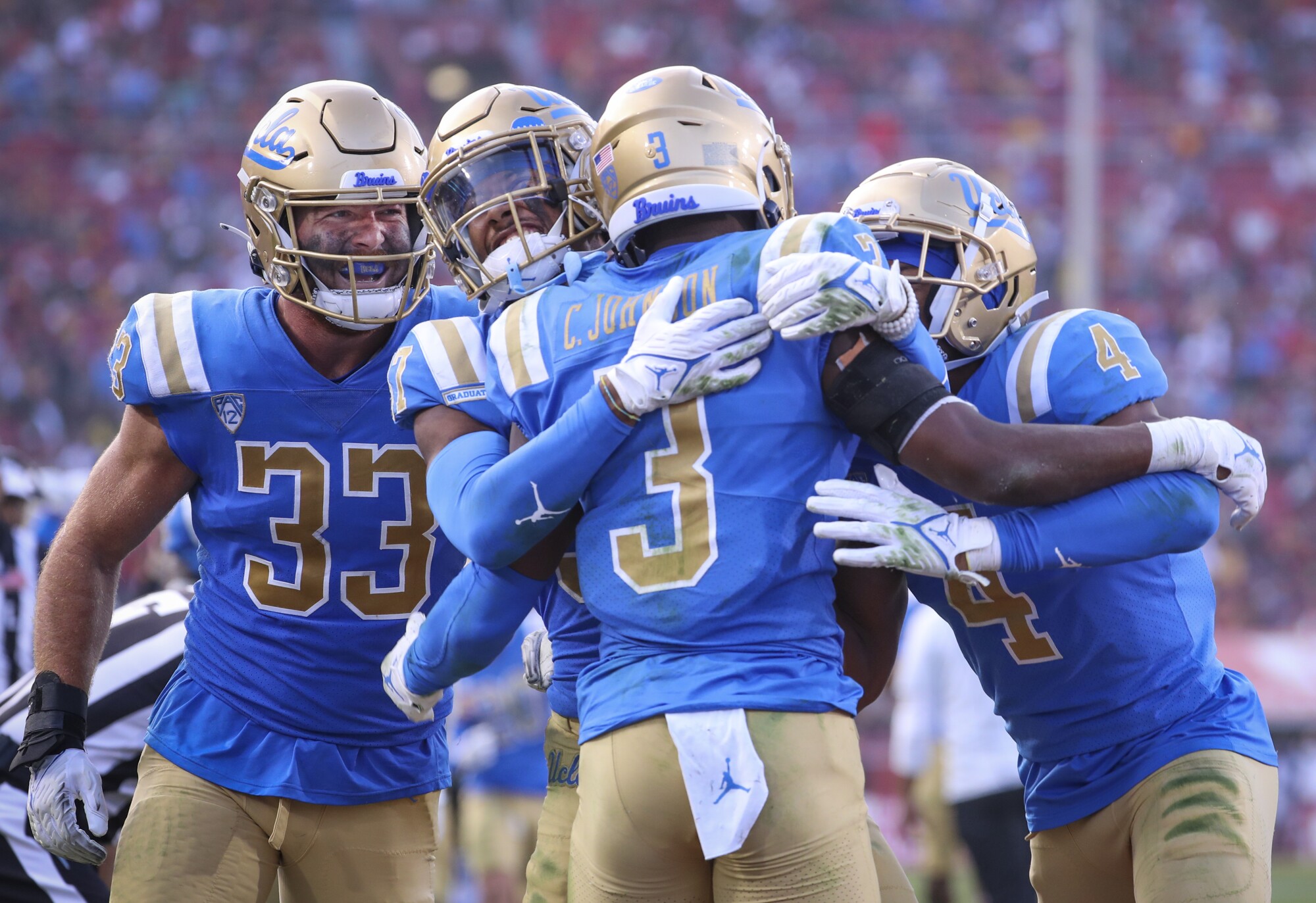 UCLA players celebrate defensive back Cameron Johnson's second half interception.