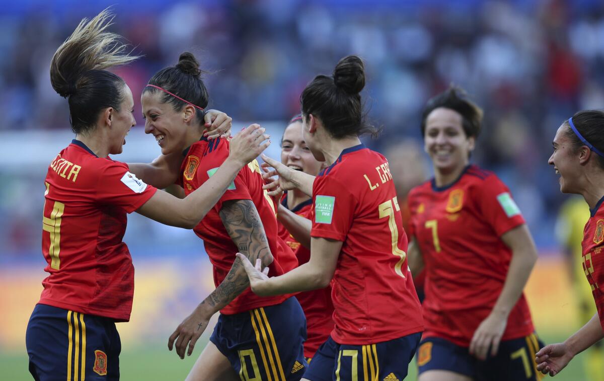 Spain's Jennifer Hermoso, second left, celebrates with teammates after scoring.