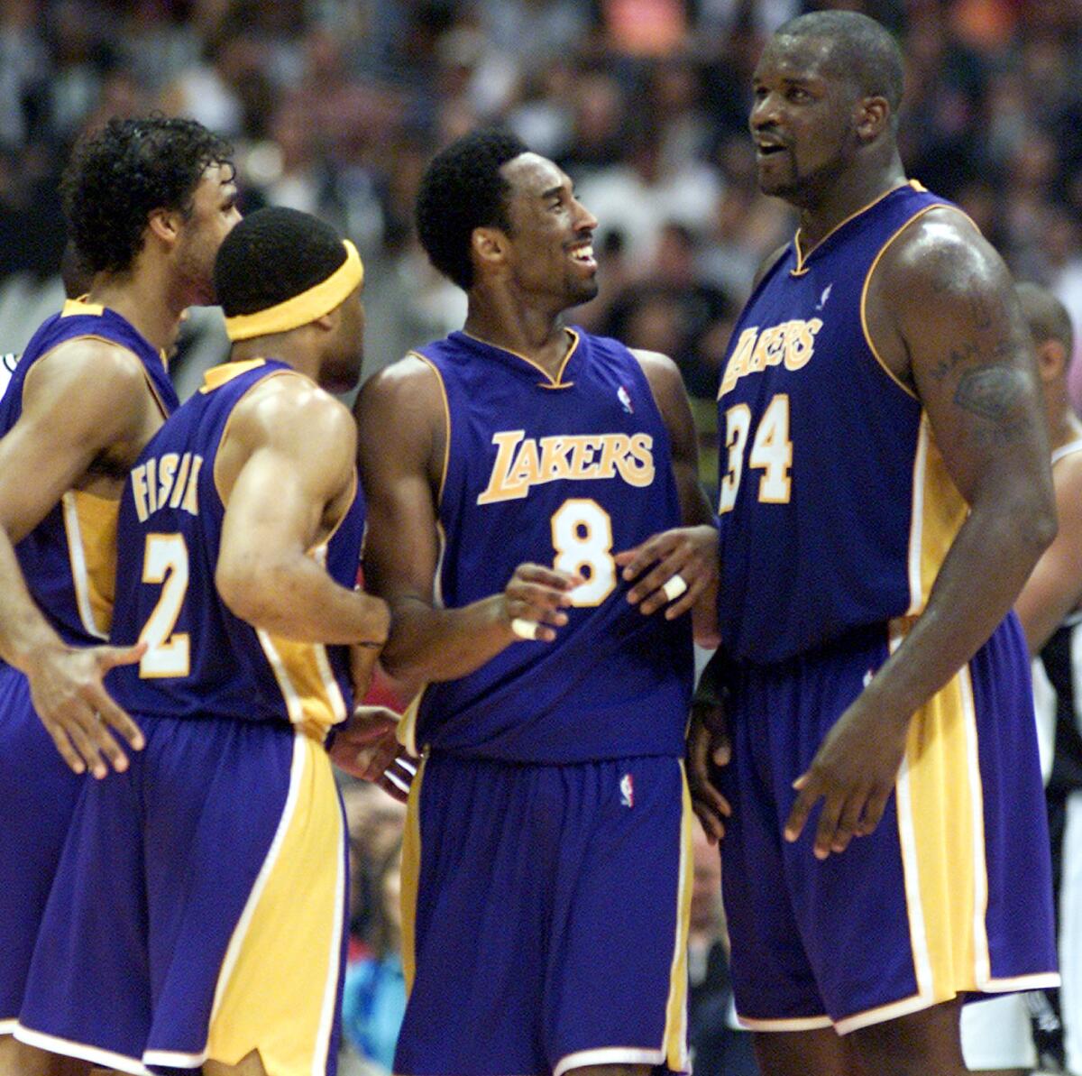 Kobe Bryant is congratulated by teammates Shaquille O'Neal, Derek Fisher and Rick Fox  after drawing a foul in a 104-90 victory over the Spurs.